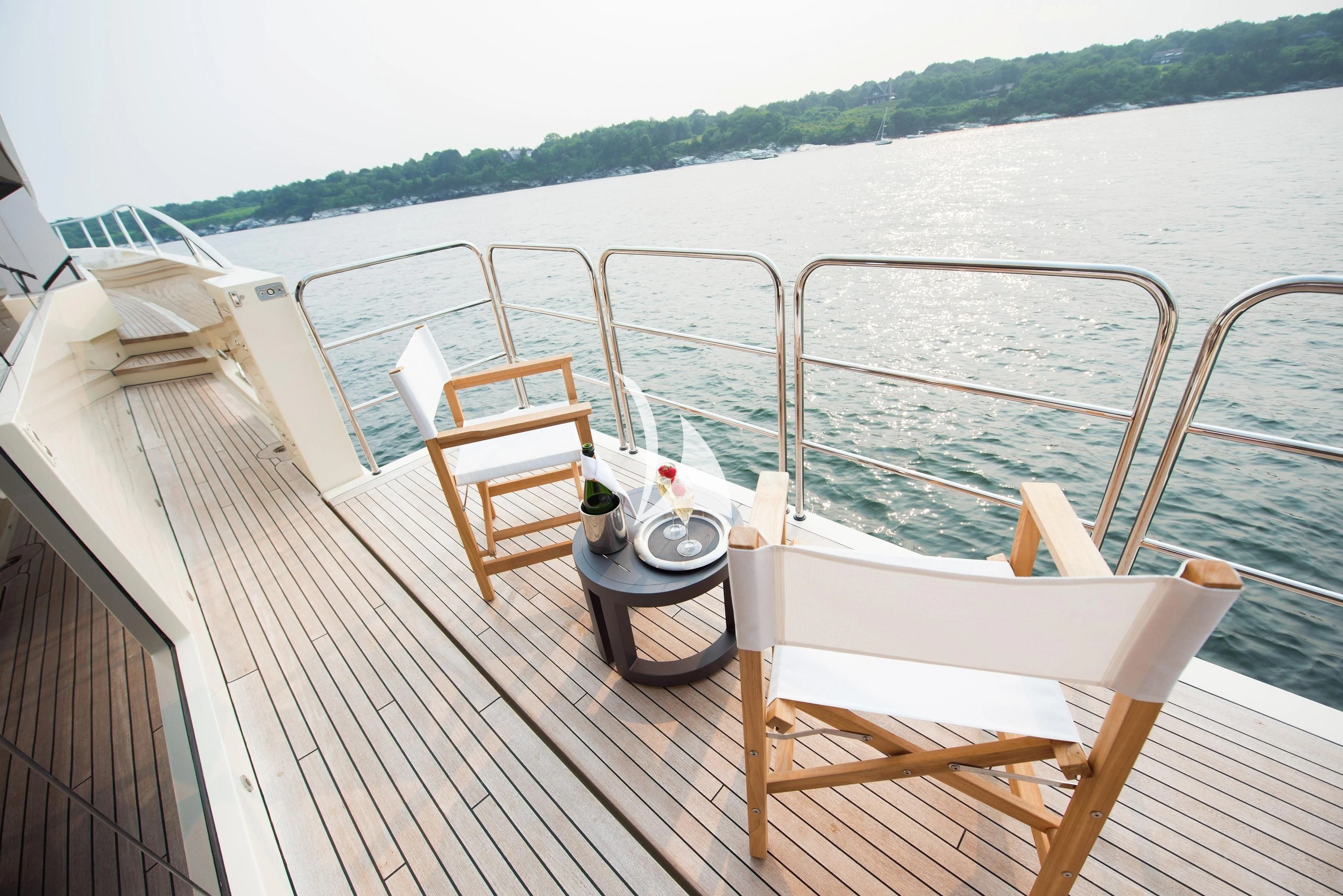 a deck with a chair and a table on it aboard STEALTH Yacht for Sale