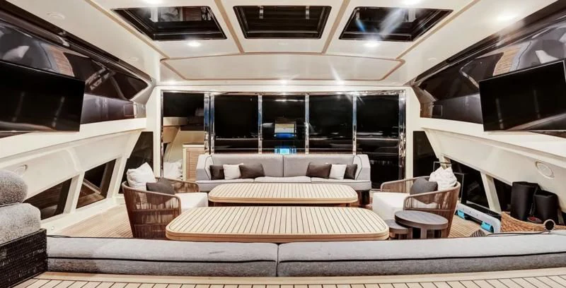 a room with a couch and a television aboard STEALTH Yacht for Sale