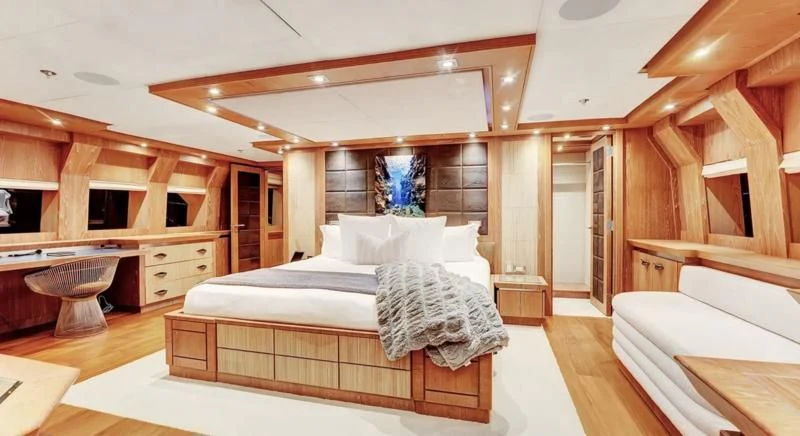 a room with a bed and a desk aboard STEALTH Yacht for Sale