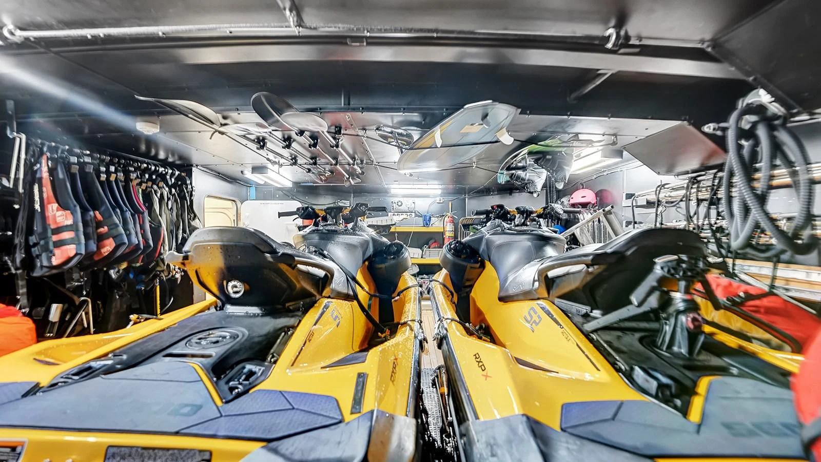 a group of cars in a garage aboard STEALTH Yacht for Sale