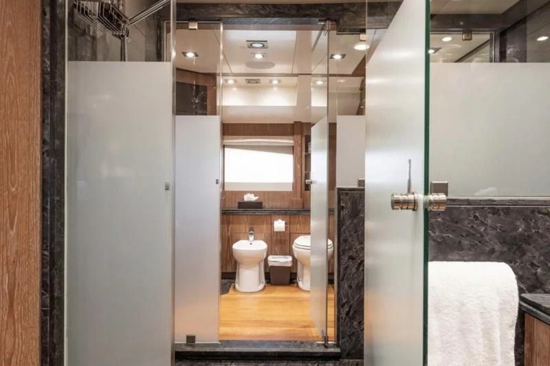 a bathroom with a glass shower aboard STEALTH Yacht for Sale