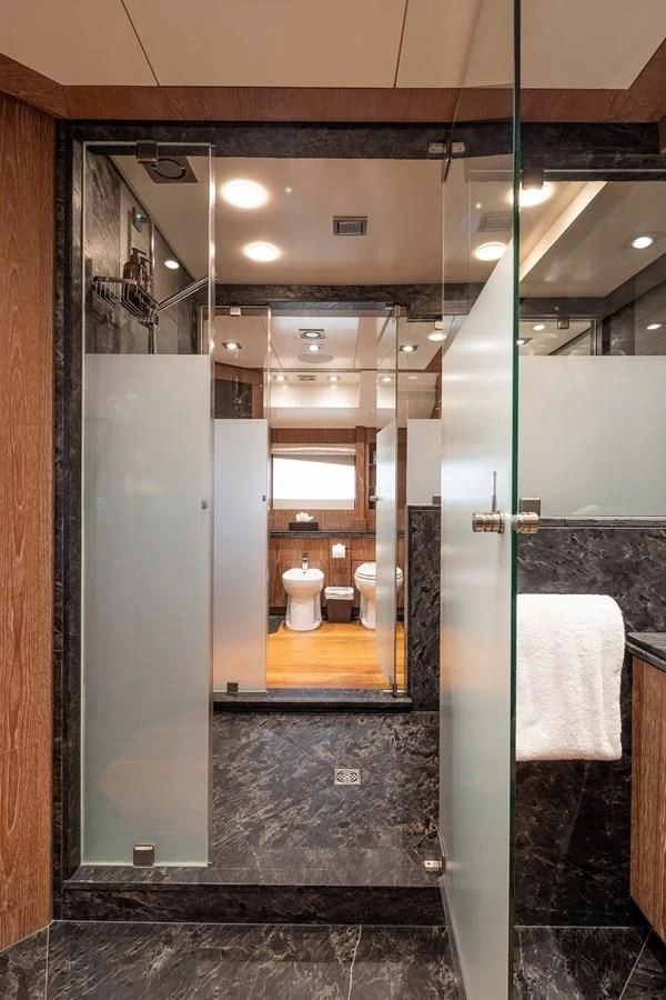 a bathroom with a glass shower aboard STEALTH Yacht for Sale