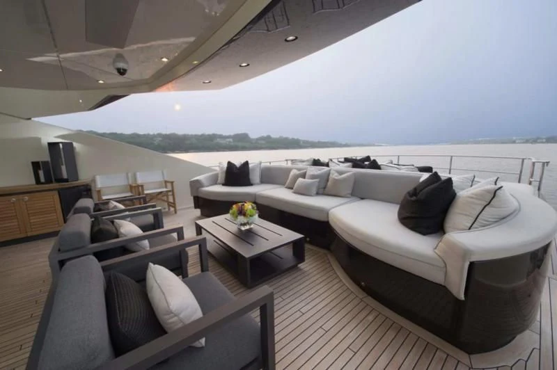 a living room with a couch and a table aboard STEALTH Yacht for Sale