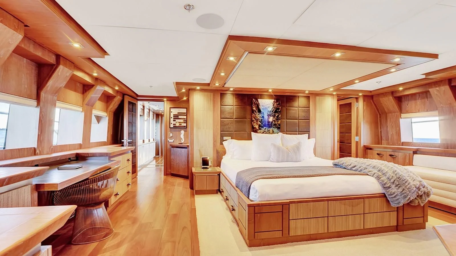 a room with a bed and a table aboard STEALTH Yacht for Sale