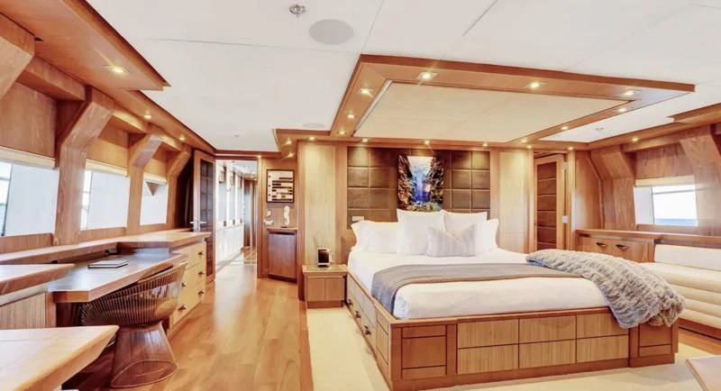 a large bedroom with a large bed aboard STEALTH Yacht for Sale