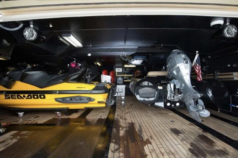 a yellow and black car aboard STEALTH Yacht for Sale