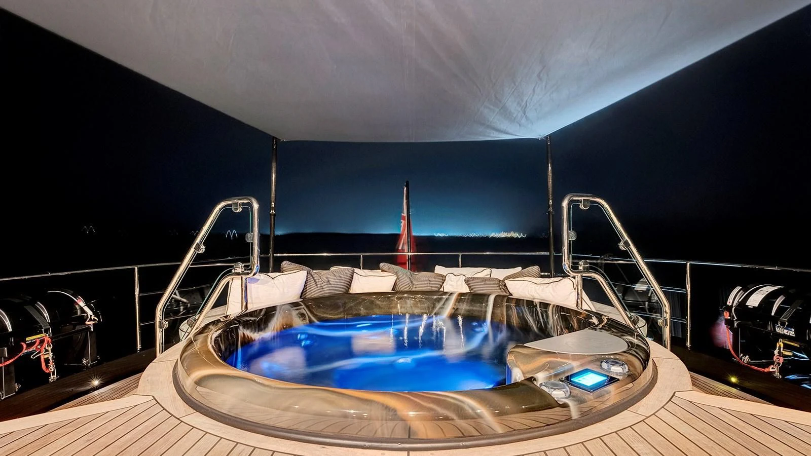 a large bed with a blue canopy aboard STEALTH Yacht for Sale