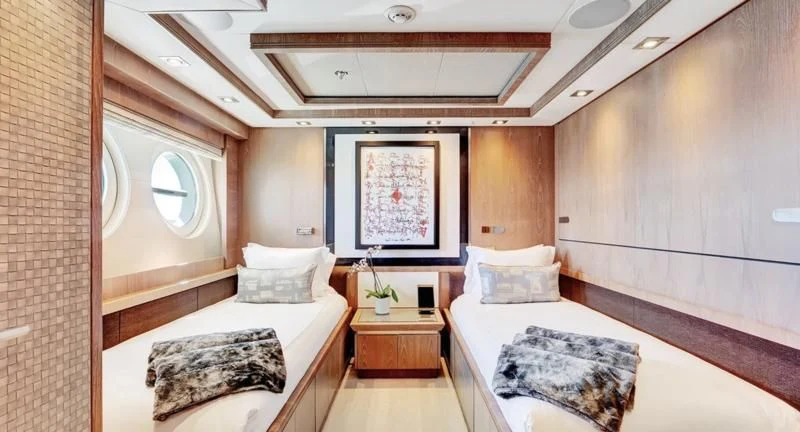 a room with a bed and a mirror aboard STEALTH Yacht for Sale