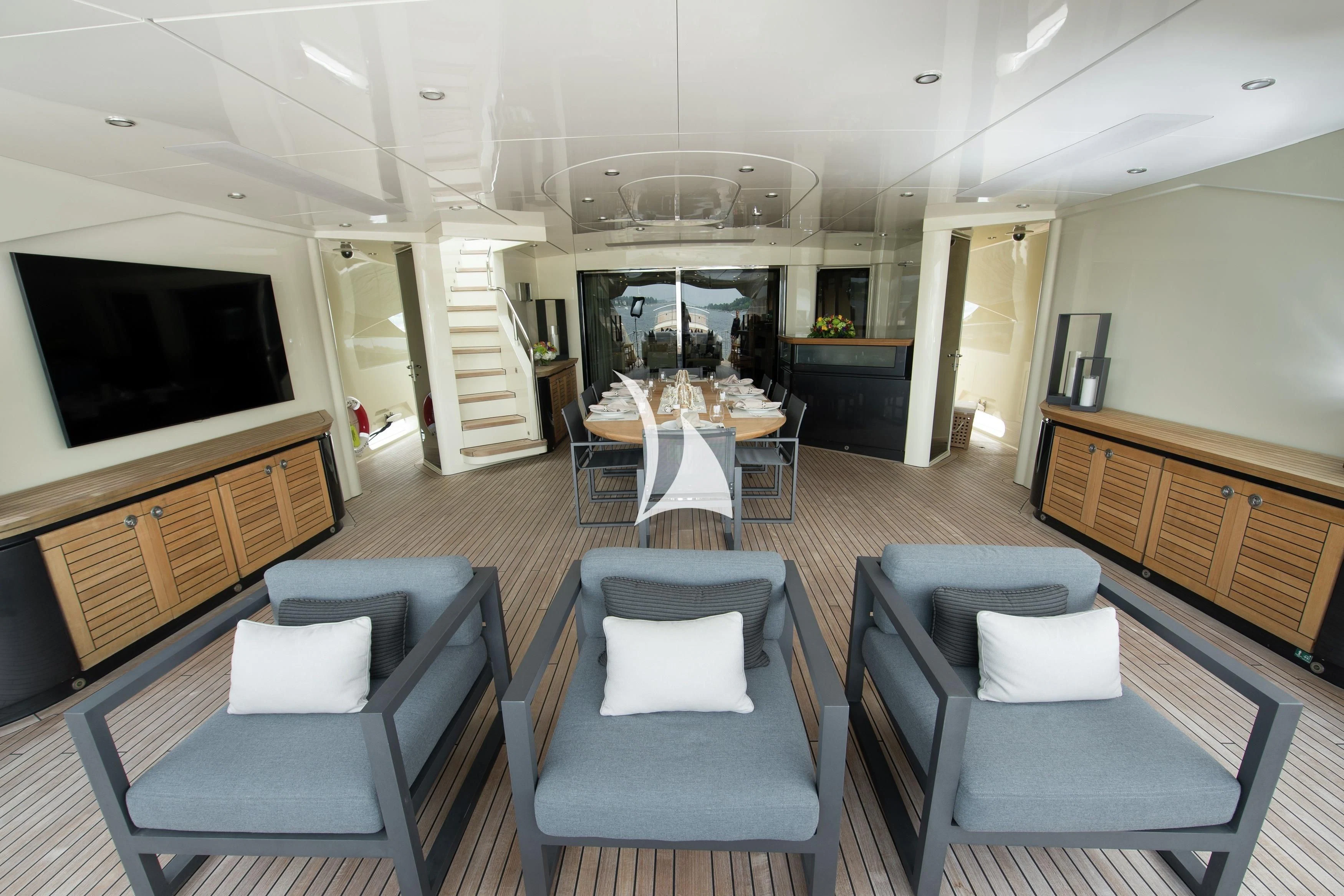 a living room with a large table and chairs aboard STEALTH Yacht for Sale