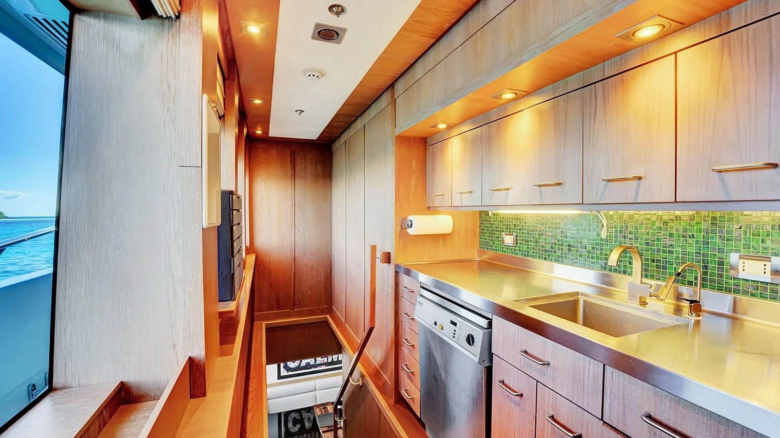 a kitchen with wooden cabinets aboard STEALTH Yacht for Sale
