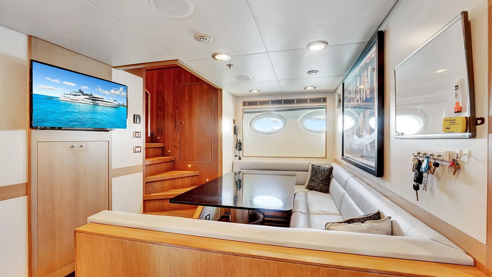 a room with a bed and a tv on the wall aboard STEALTH Yacht for Sale