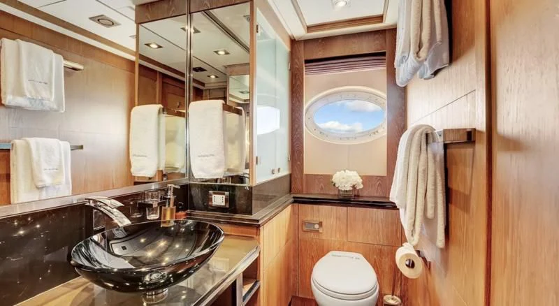 a bathroom with a sink and a mirror aboard STEALTH Yacht for Sale