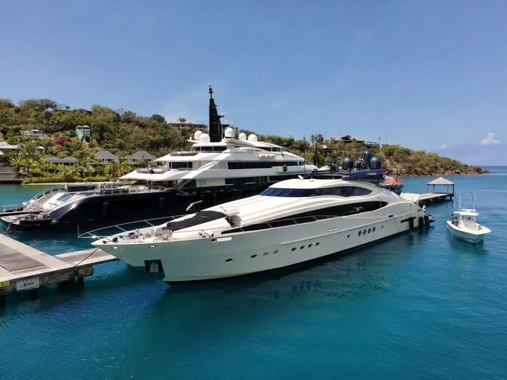 a large white yacht docked at a dock aboard STEALTH Yacht for Sale