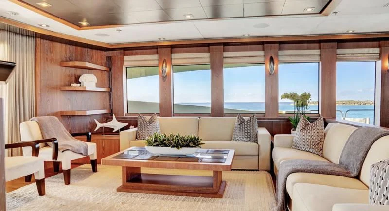 a living room with a table and chairs aboard STEALTH Yacht for Sale