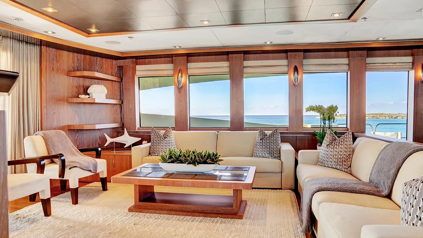 a living room with a table and chairs aboard STEALTH Yacht for Sale