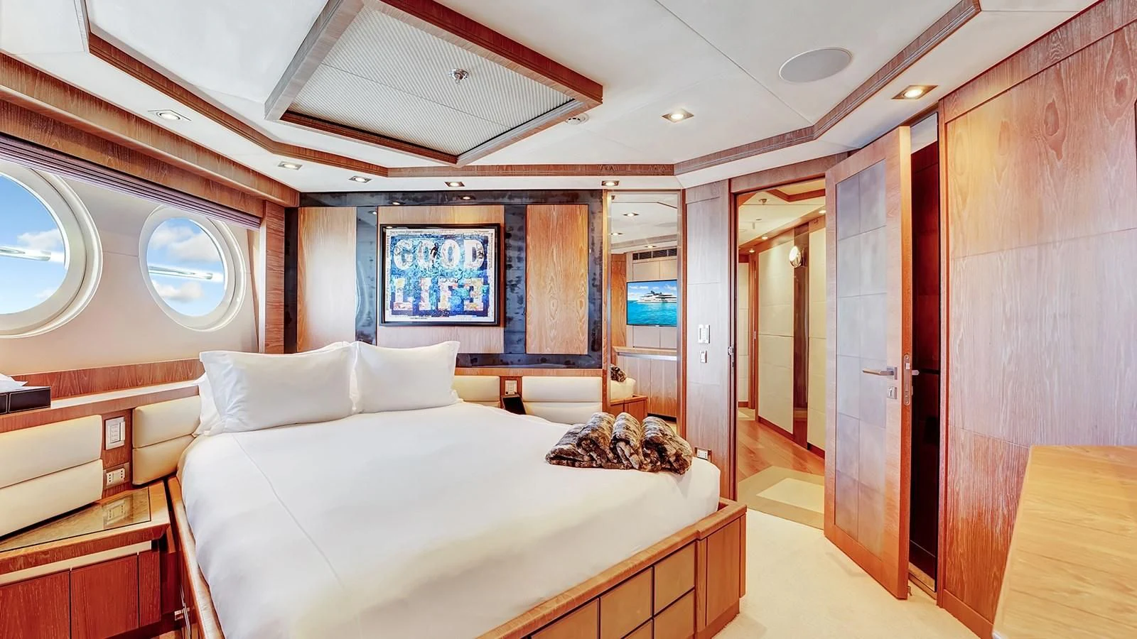 a room with a bed and a mirror aboard STEALTH Yacht for Sale