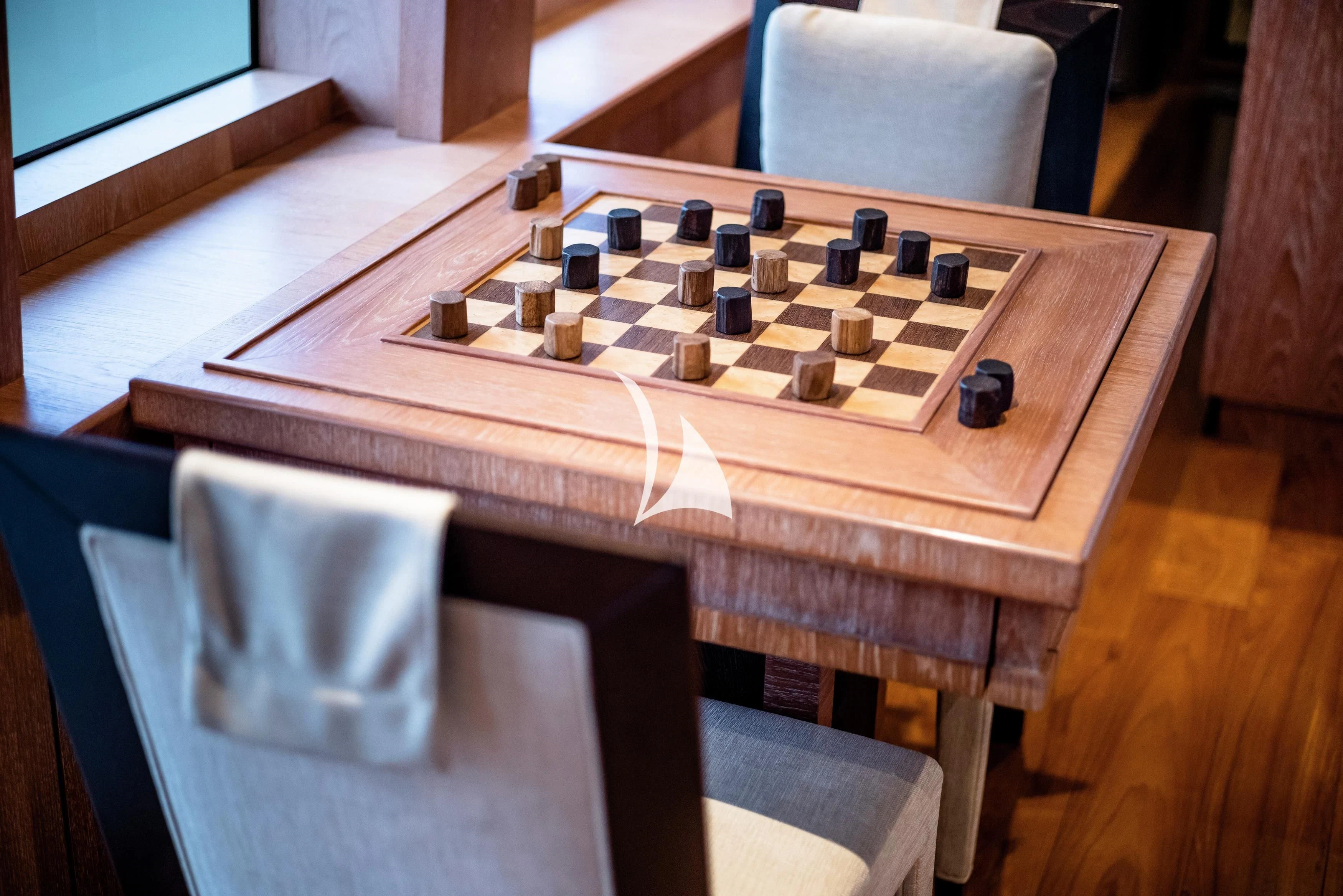 a wooden table with a white plastic model of a ship on it aboard STEALTH Yacht for Sale