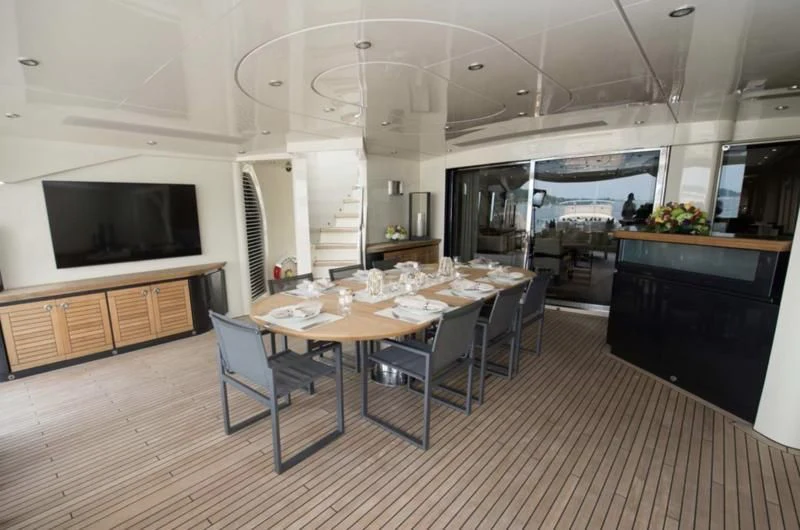 a large room with a table and chairs aboard STEALTH Yacht for Sale