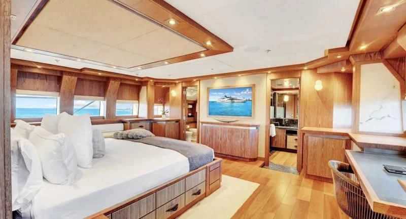 a room with a bed and a television aboard STEALTH Yacht for Sale