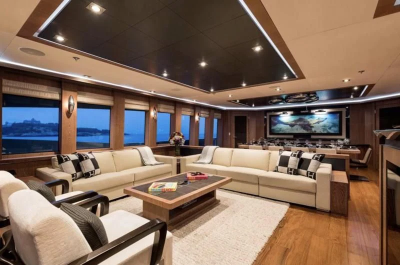 a living room with a large screen aboard STEALTH Yacht for Sale