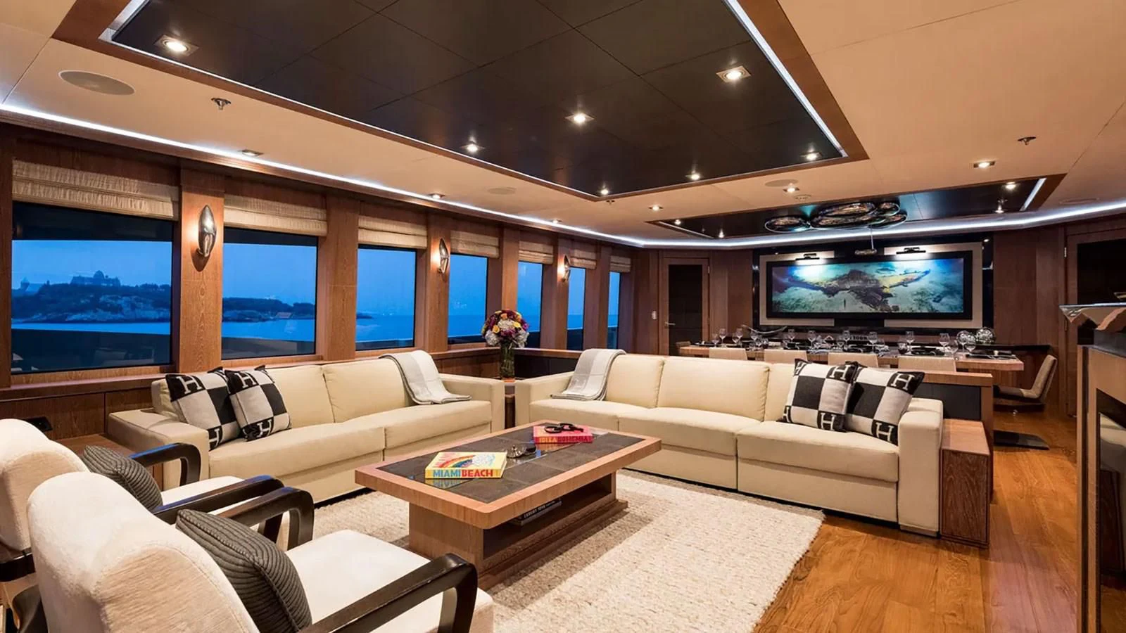 a living room with a large screen aboard STEALTH Yacht for Sale
