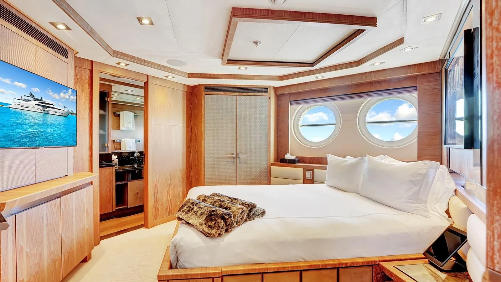 a room with a bed and a window aboard STEALTH Yacht for Sale