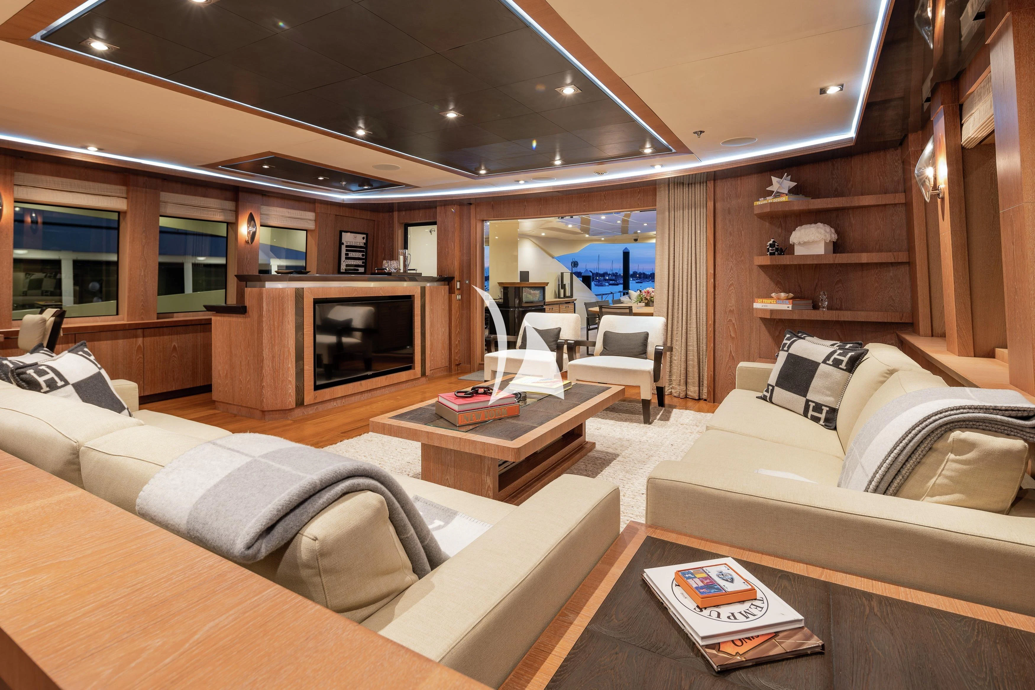 a living room with a fireplace aboard STEALTH Yacht for Sale