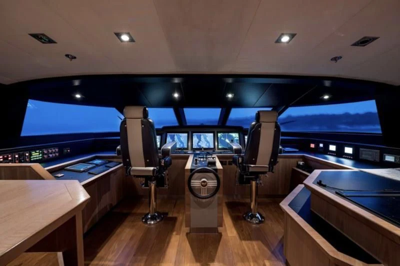 a room with a tv and a table aboard STEALTH Yacht for Sale