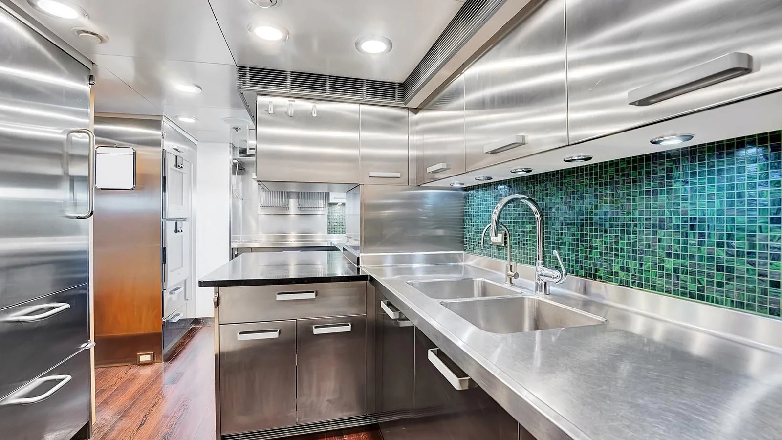 a kitchen with a sink and cabinets aboard STEALTH Yacht for Sale