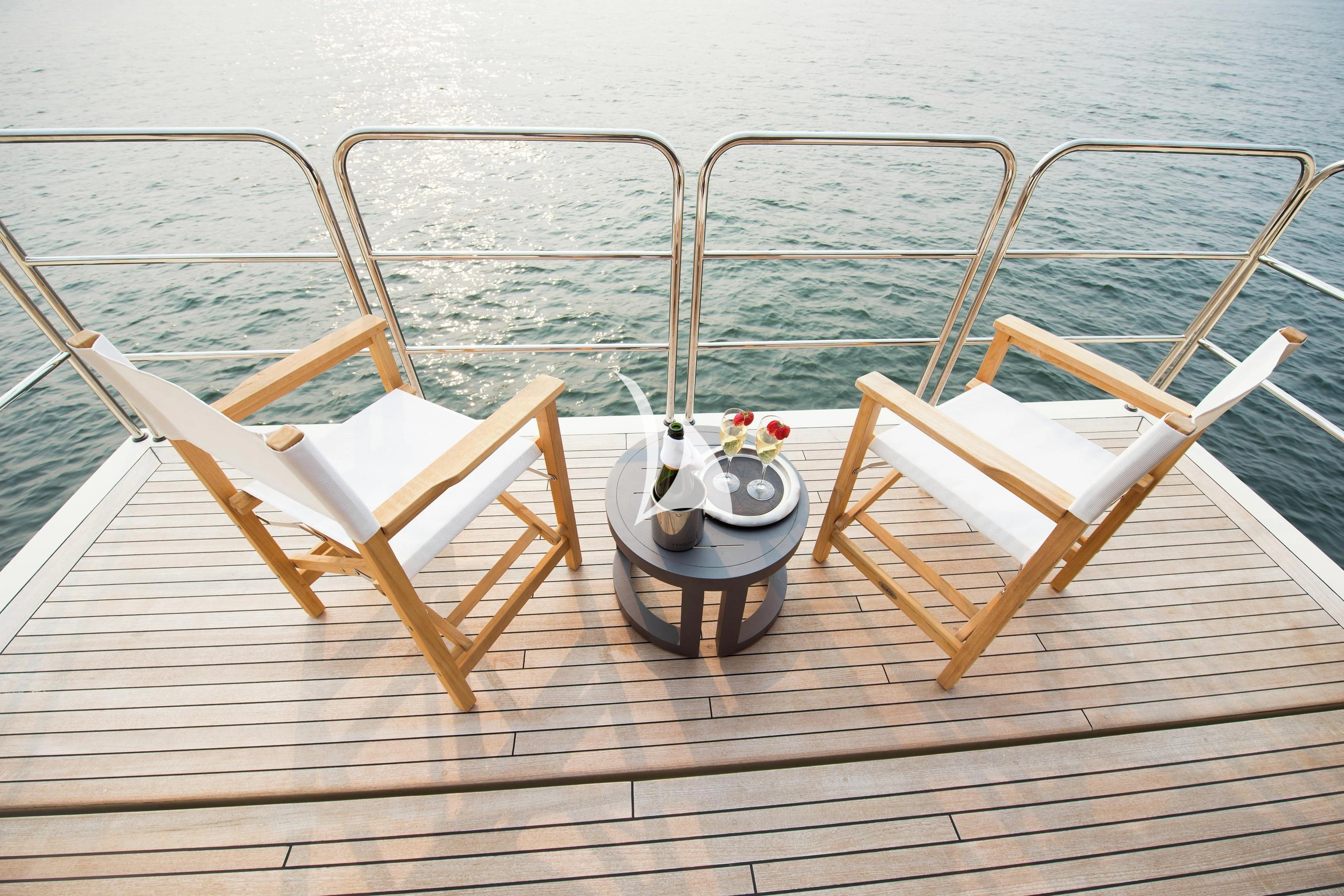 a chair and a table on a dock aboard STEALTH Yacht for Sale