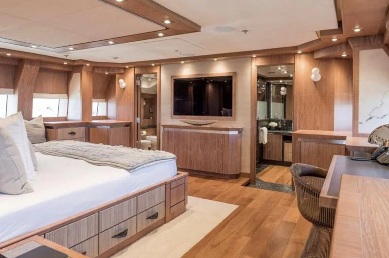 a bedroom with a bed and a television aboard STEALTH Yacht for Sale