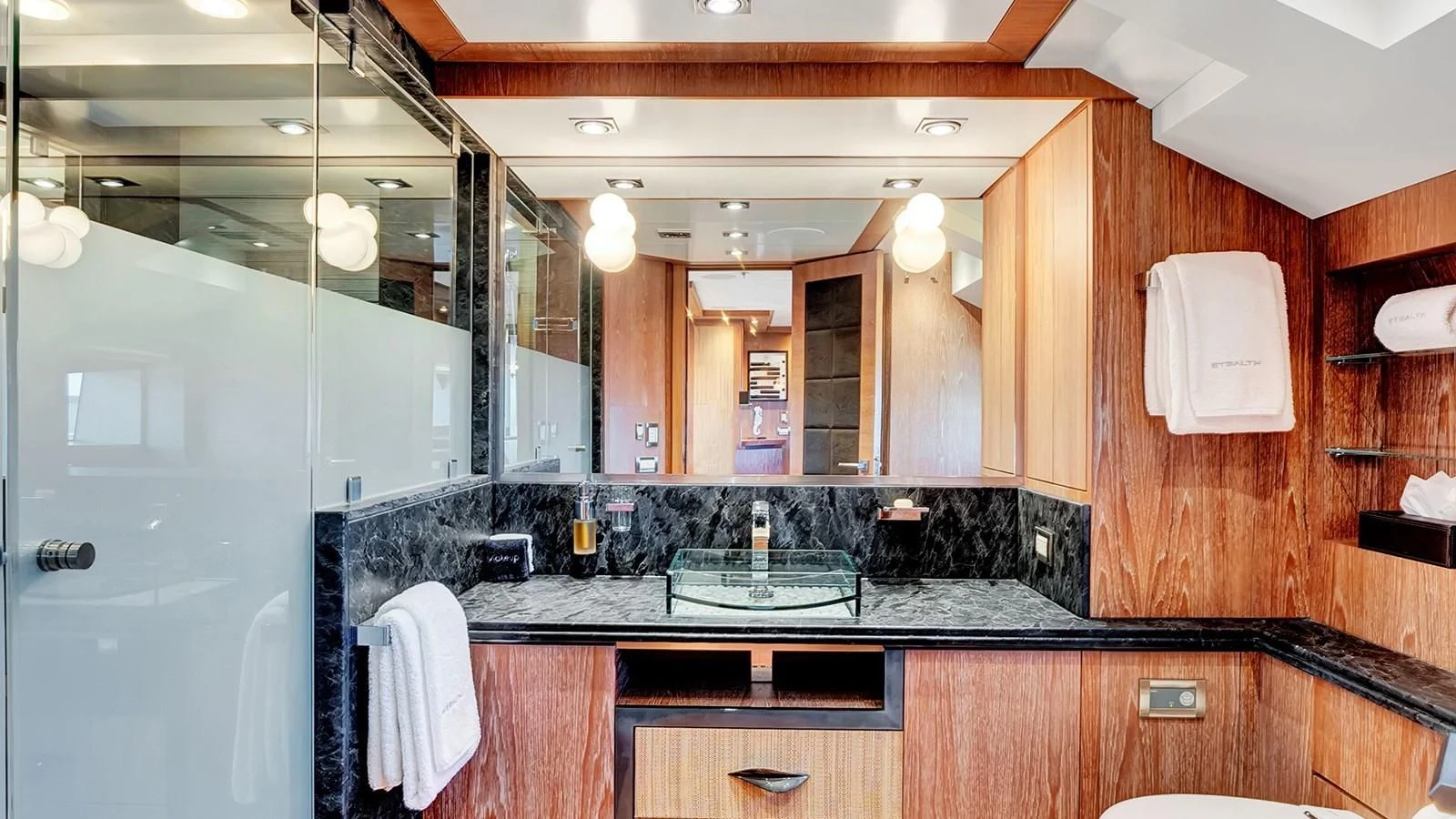 a bathroom with a glass shower aboard STEALTH Yacht for Sale