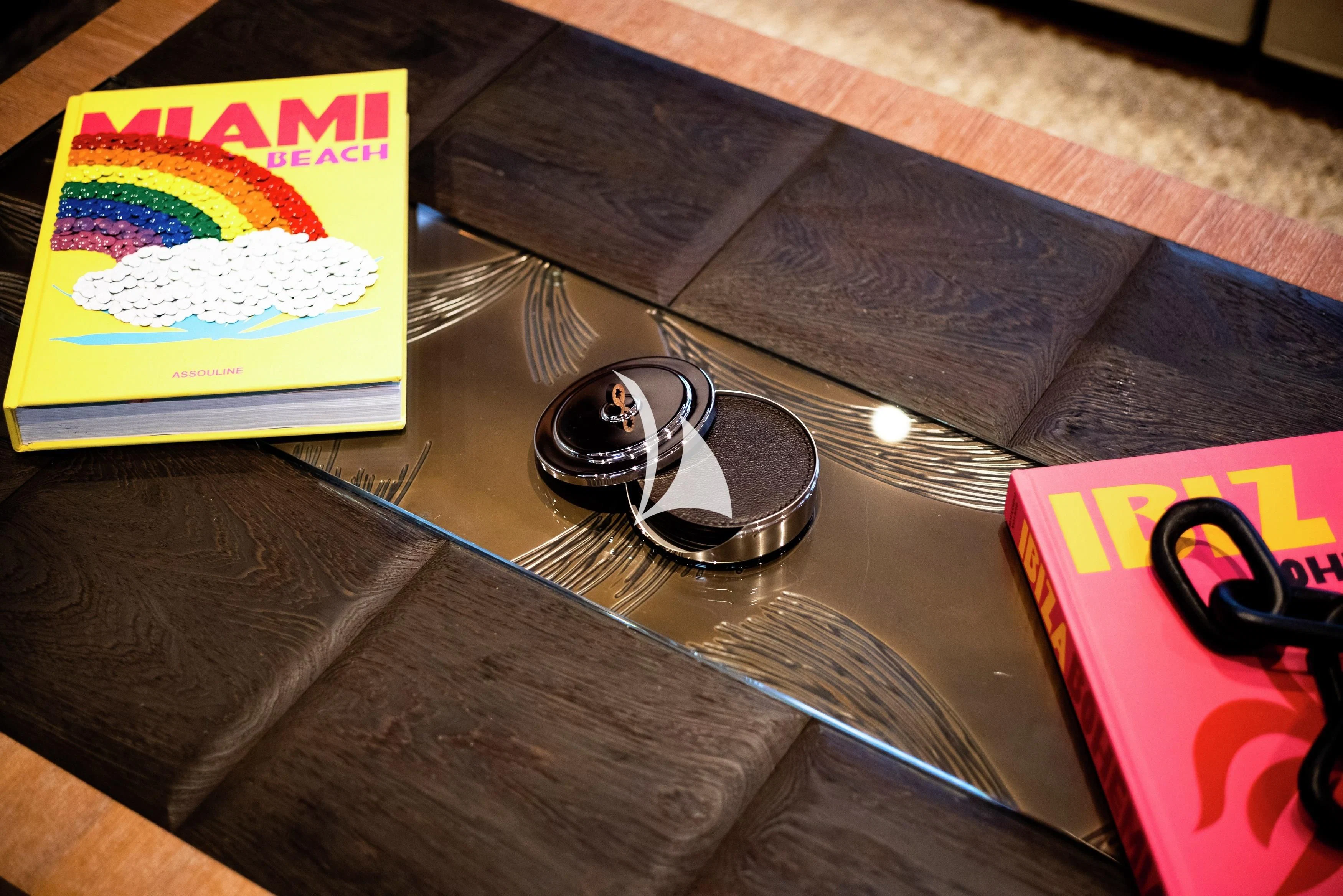 a table with a wallet and a pair of sunglasses on it aboard STEALTH Yacht for Sale