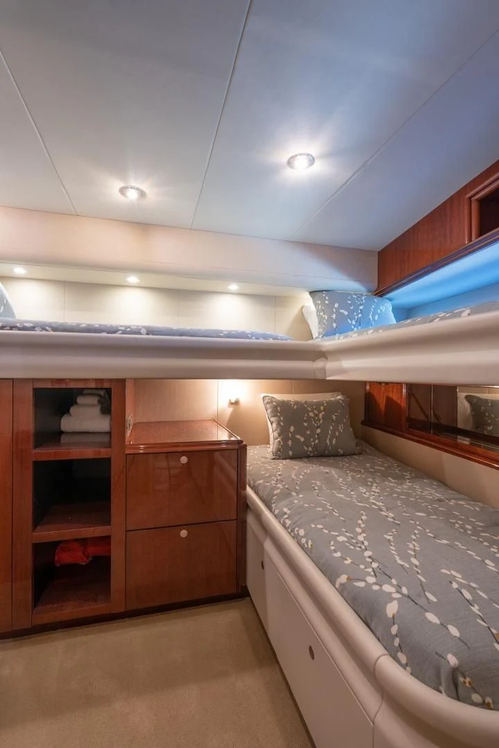 a bedroom with a bed and a shelf aboard SUMMERWIND Yacht for Sale