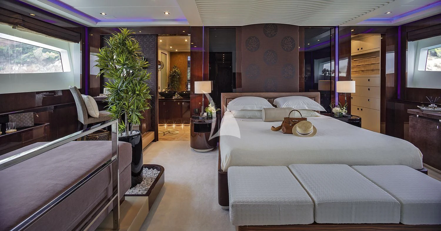 a room with a bed and a chair aboard MY TOY Yacht for Sale