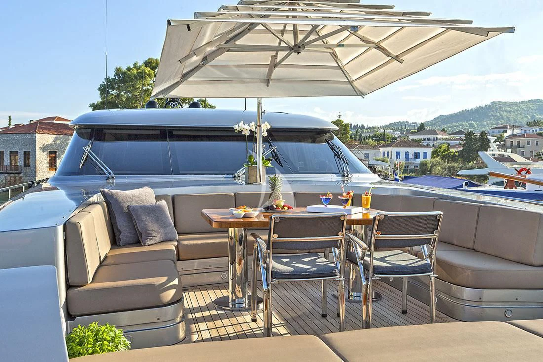 a patio with a table and chairs aboard MY TOY Yacht for Sale