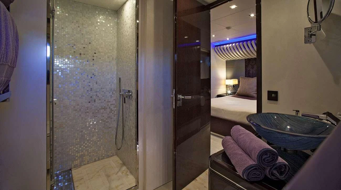 a bathroom with a sink and a bed aboard MY TOY Yacht for Sale