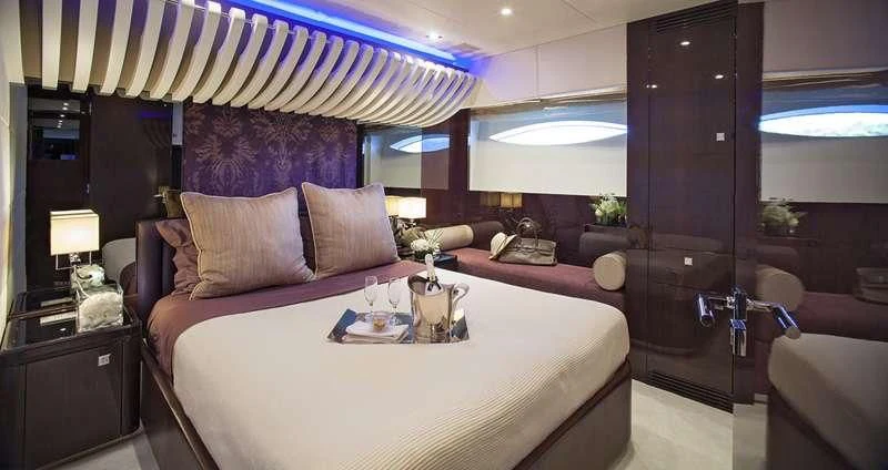 a bed with a white sheet and pillows aboard MY TOY Yacht for Sale