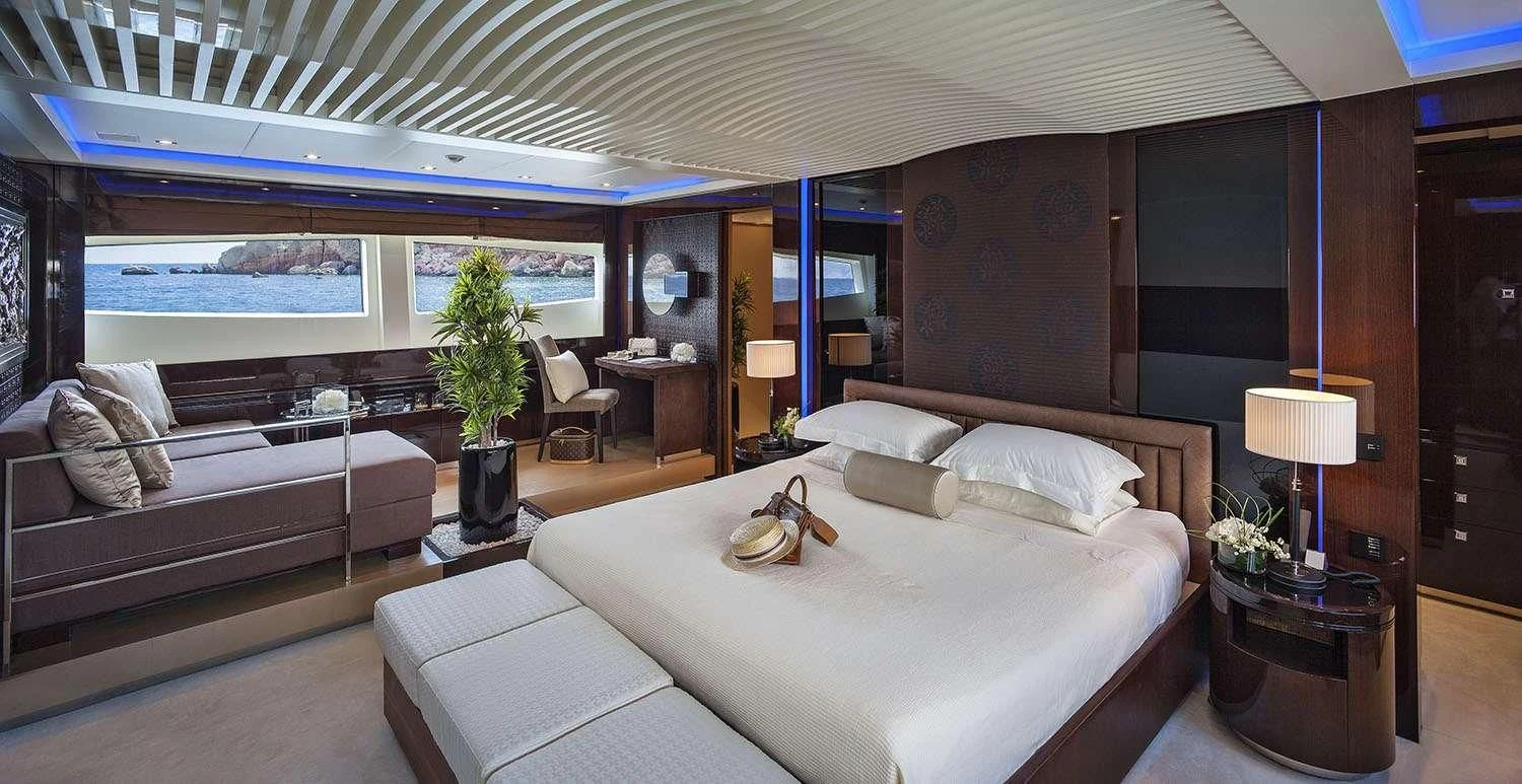 a room with a bed and a couch aboard MY TOY Yacht for Sale