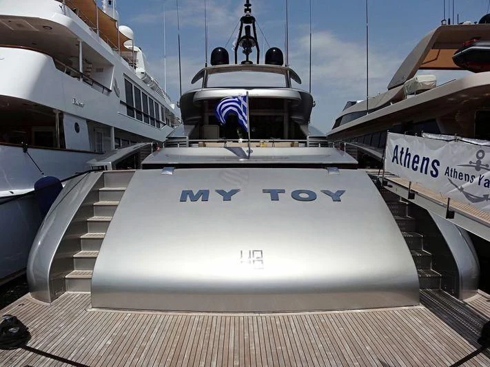 a white boat with blue lettering aboard MY TOY Yacht for Sale