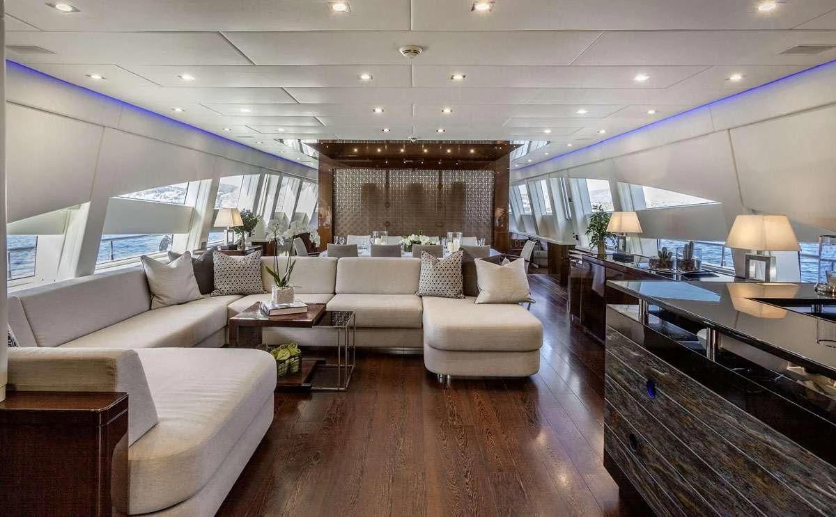 a living room with a large mirror aboard MY TOY Yacht for Sale