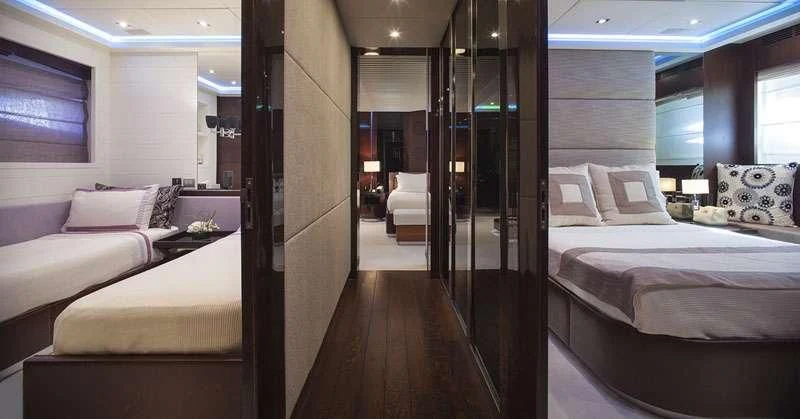 a room with a bed and a mirror aboard MY TOY Yacht for Sale