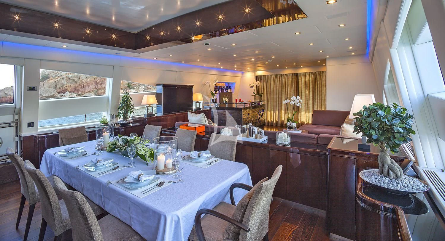 a large room with tables and chairs aboard MY TOY Yacht for Sale