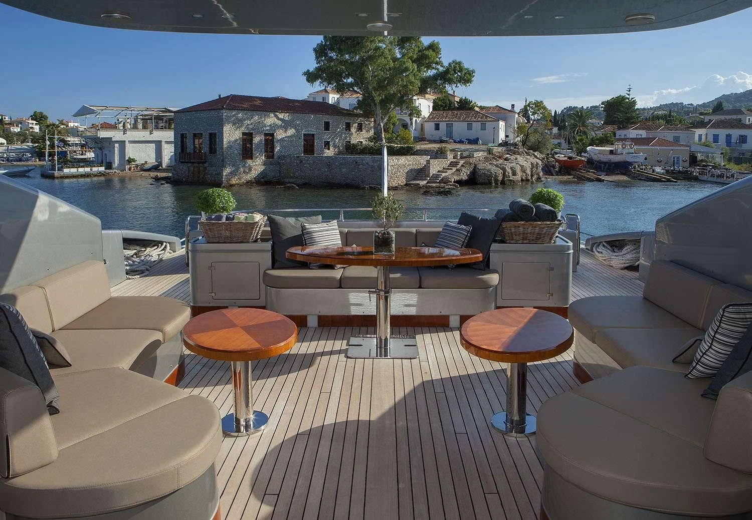 a patio with tables and chairs aboard MY TOY Yacht for Sale