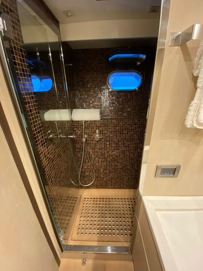 a shower unit with a blue seat aboard @LAST Yacht for Sale