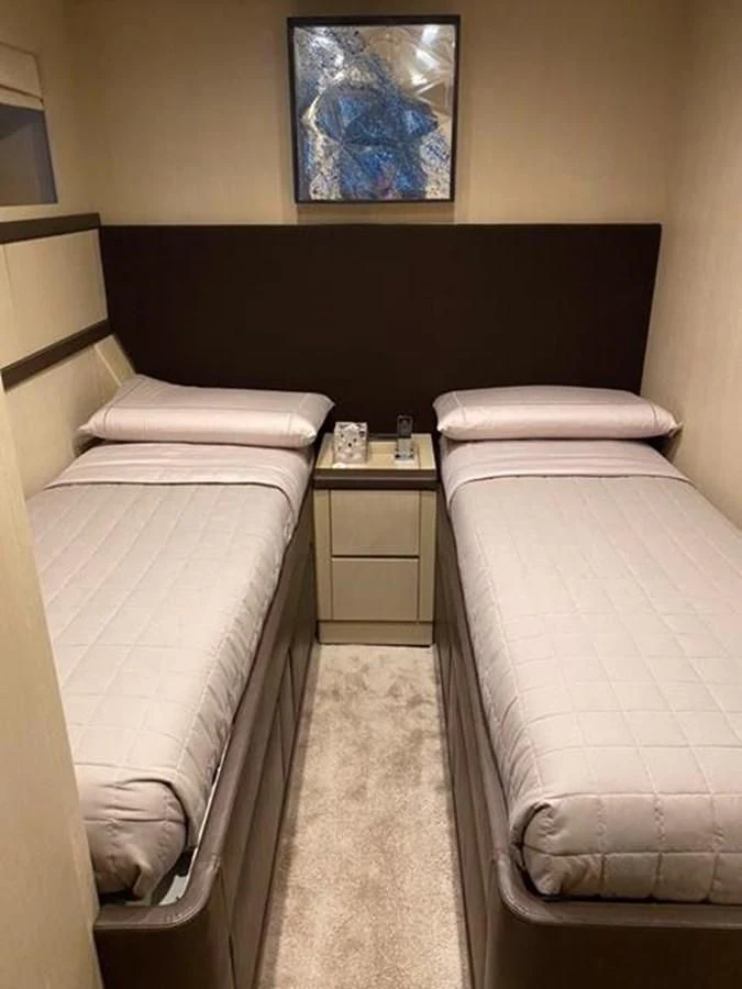 a bed with a wooden headboard aboard @LAST Yacht for Sale