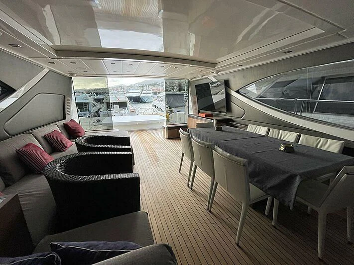 a room with a couch and a table and chairs aboard @LAST Yacht for Sale