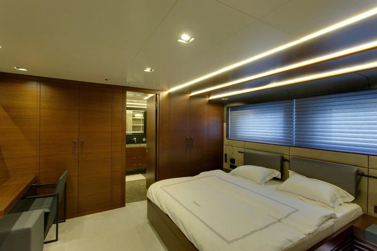 a room with a bed and a desk aboard BEBE Yacht for Sale