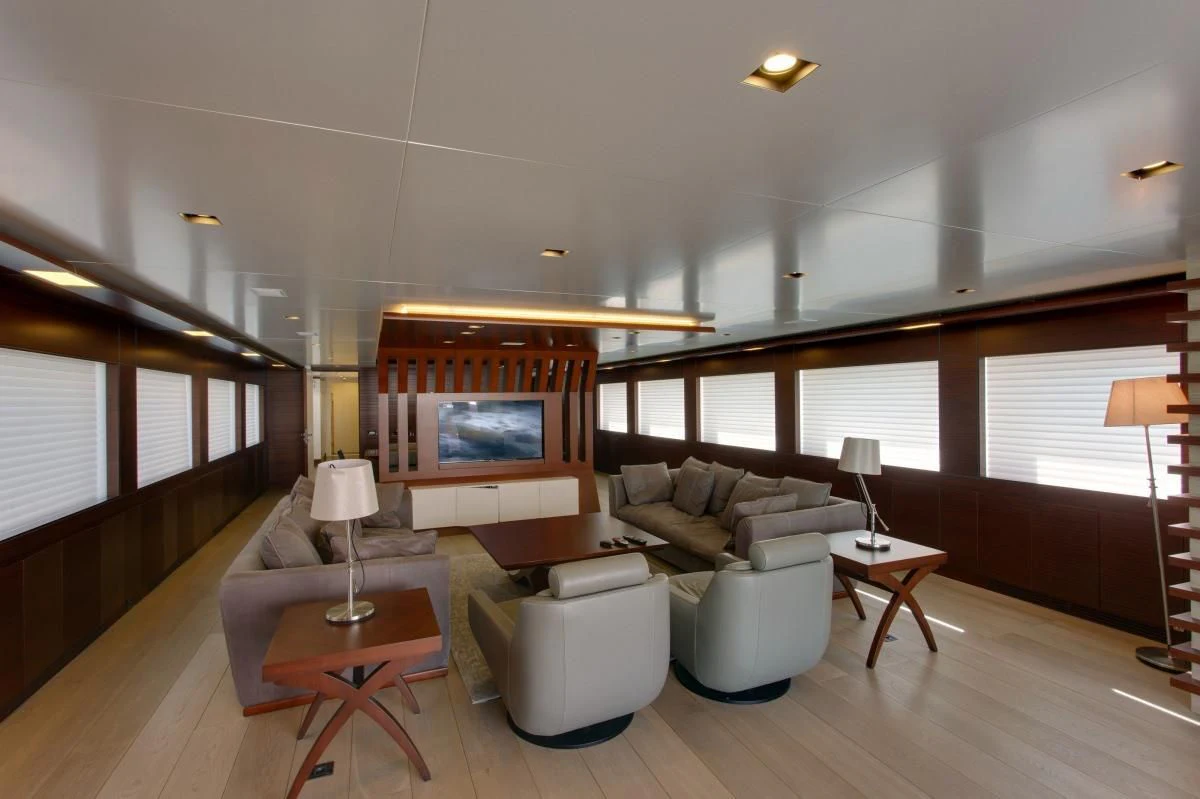 a living room with a large television aboard BEBE Yacht for Sale