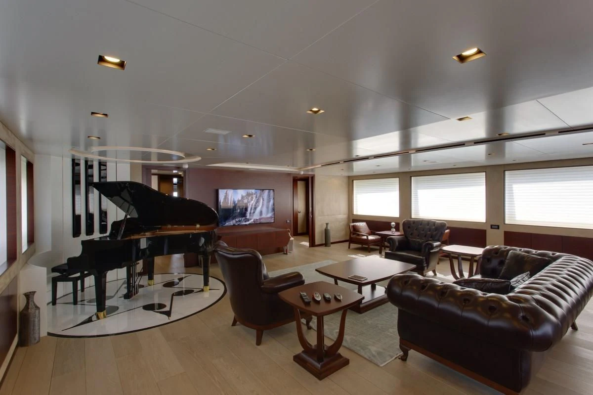 a living room with a piano and a large piano aboard BEBE Yacht for Sale